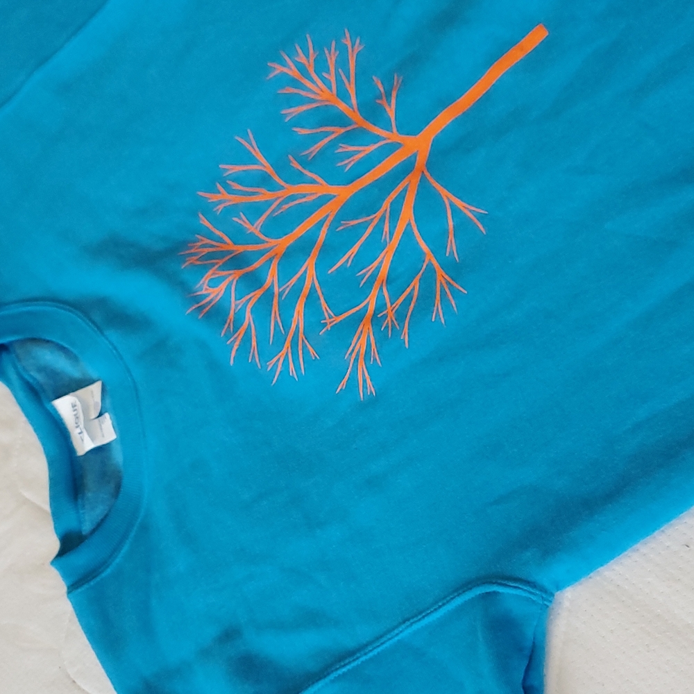 Clique - Vibrant blue crew neck featuring printed orange tree decal (US S)